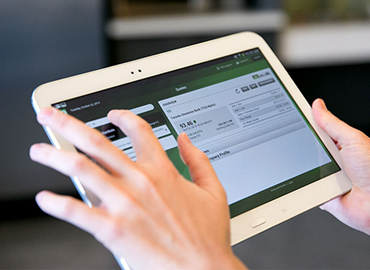 a person holding a tablet using it for their online banking